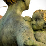 statue of mother and child - attachment parenting and daycare featured image