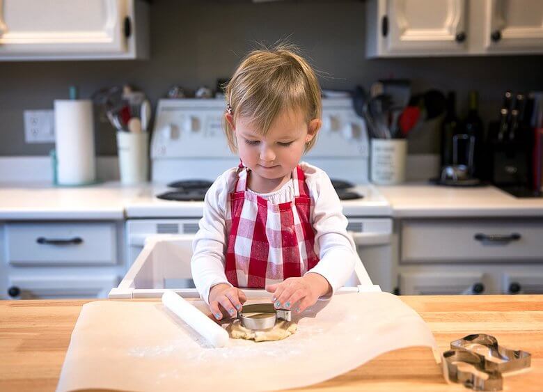 Baking with preschoolers - child using cookie cutter - article image