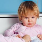 bed time chaos battles with preschoolers featured image - child pouting in bed