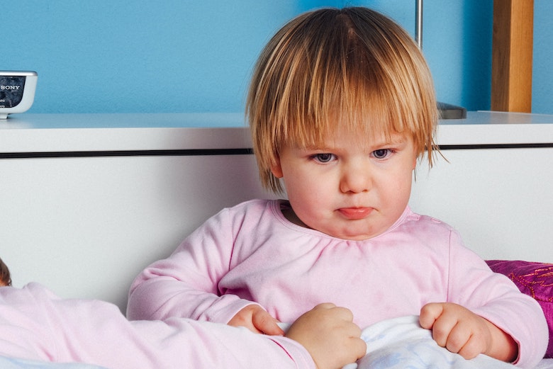 bed time chaos battles with preschoolers featured image - child pouting in bed