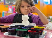 child deciding on paint colours in preschool Vancouver Child Care