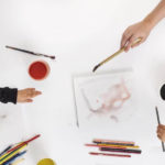 children process art activity table with paint and pencil crayons