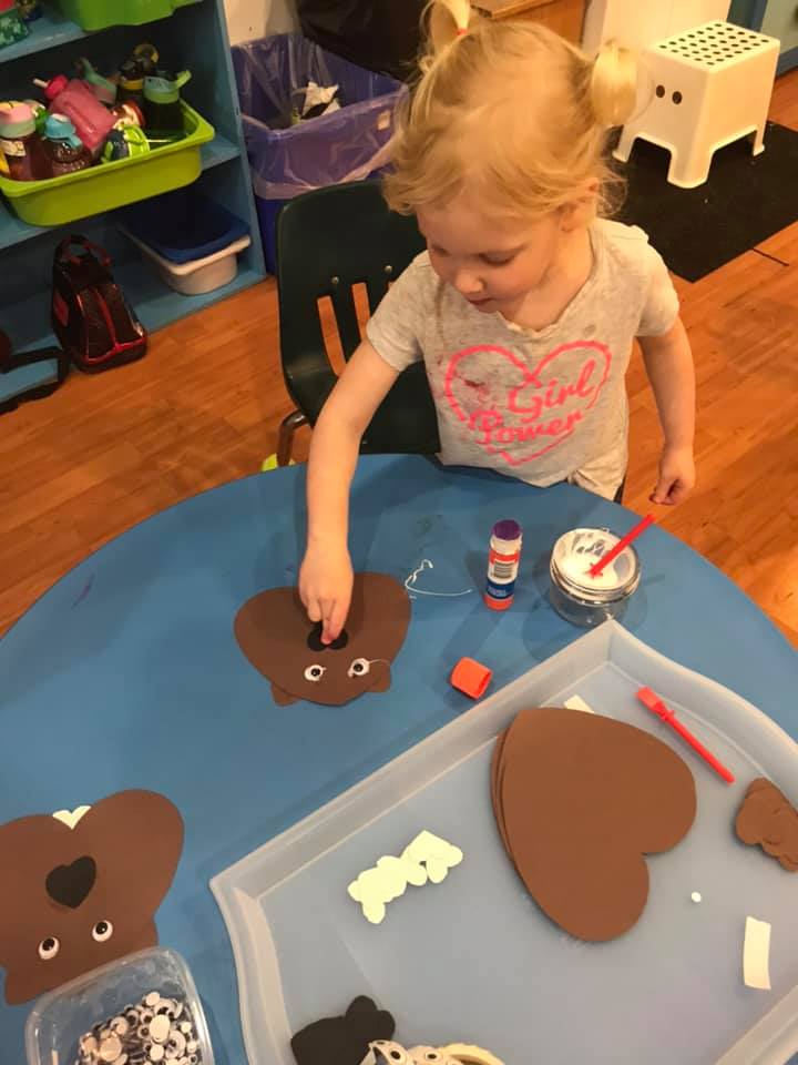 girl making beaver craft with paper at preschool
