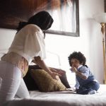 mom chasing toddler on bed - article image for helping toddler get good sleep