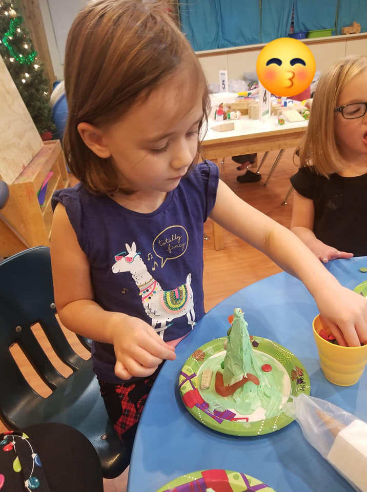 icing christmas tree craft with candy at preschool