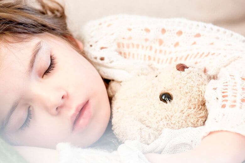 importance of sleep in early childhood article featured image of girl sleeping