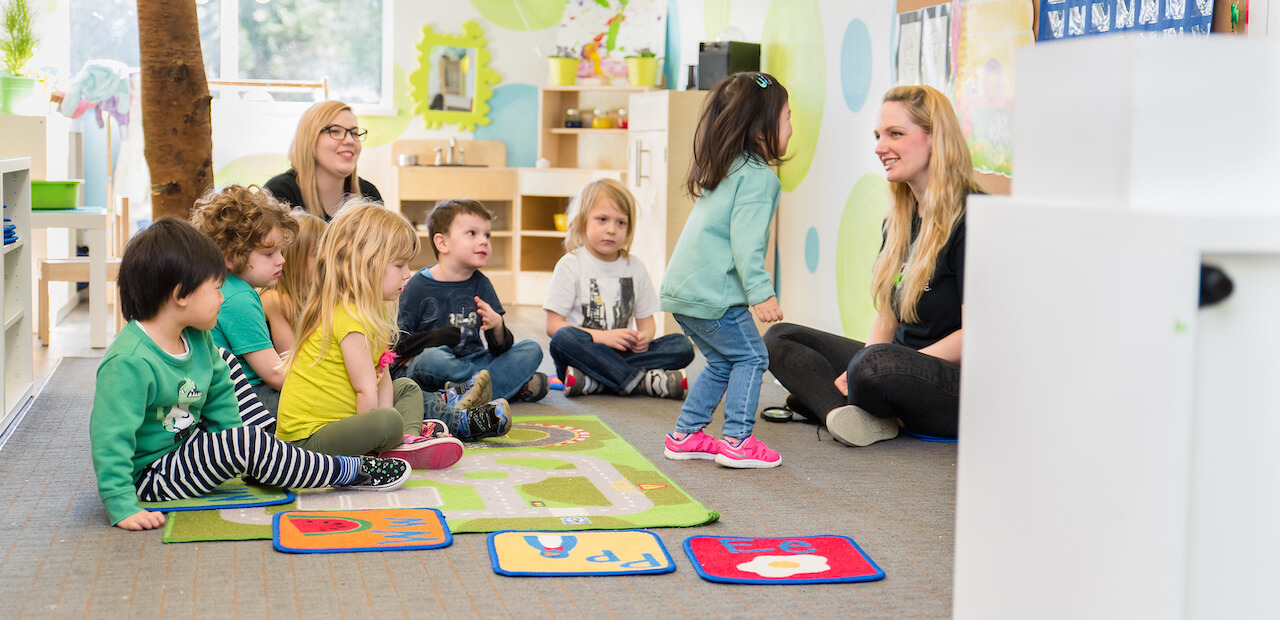 child interacting with teacher at daycare during circle time