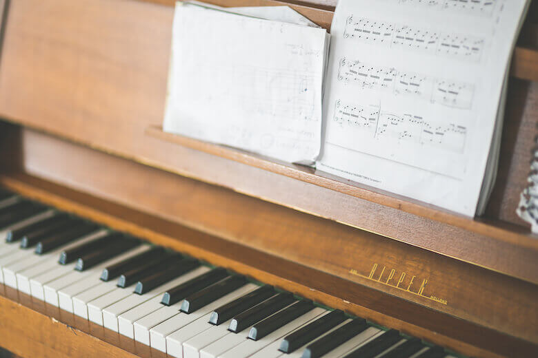 piano keys and music sheets - benefits of kids learning music article image