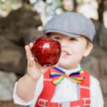 preschool child holding apple - preschool interdisciplinary apple lessons and activities image