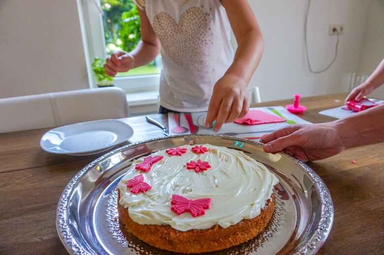 child about to touch cake while decorating