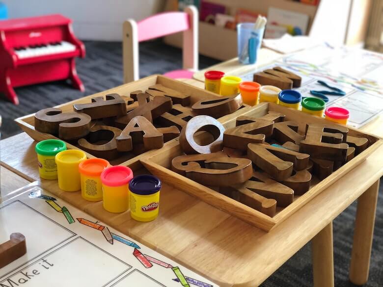 preschool classroom wood letters and playdough acting as the third teacher