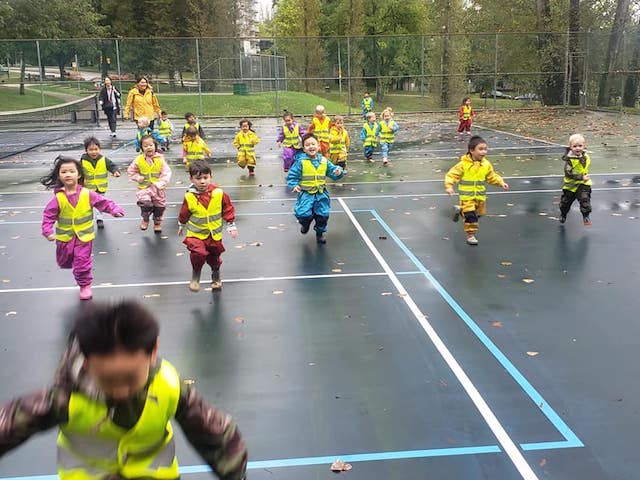 children running in an open space near a daycare 