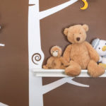 Stuffed animals on painted wall shelf in nursery - child room - myths about daycare featured image