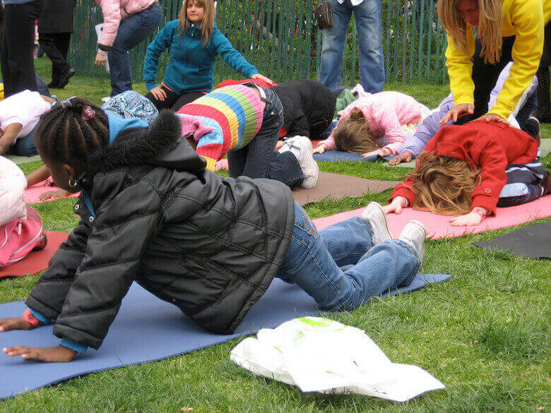 kids yoga class outside - article featured image for reasons to teach yoga at daycare
